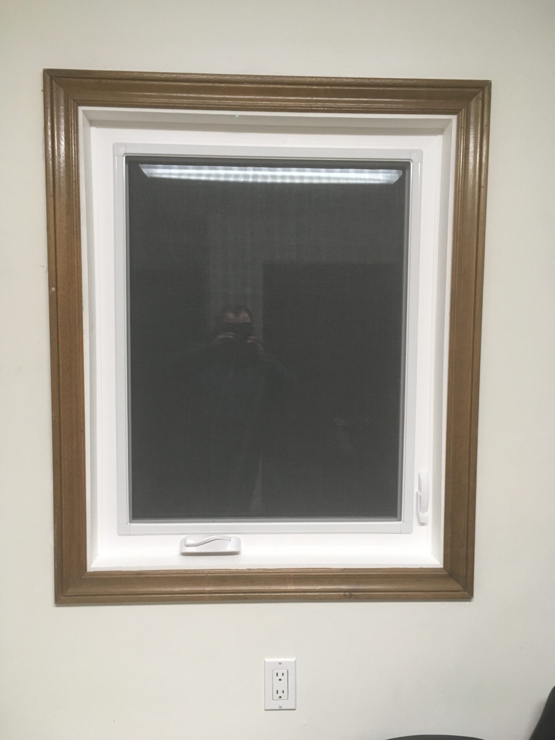 white awning window with brown frame