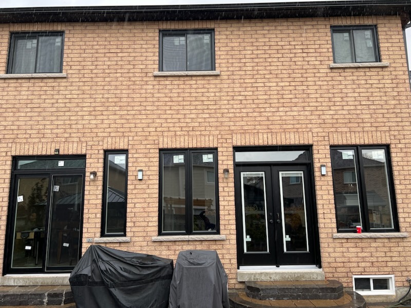 a house with single slider windows and double front entry doors