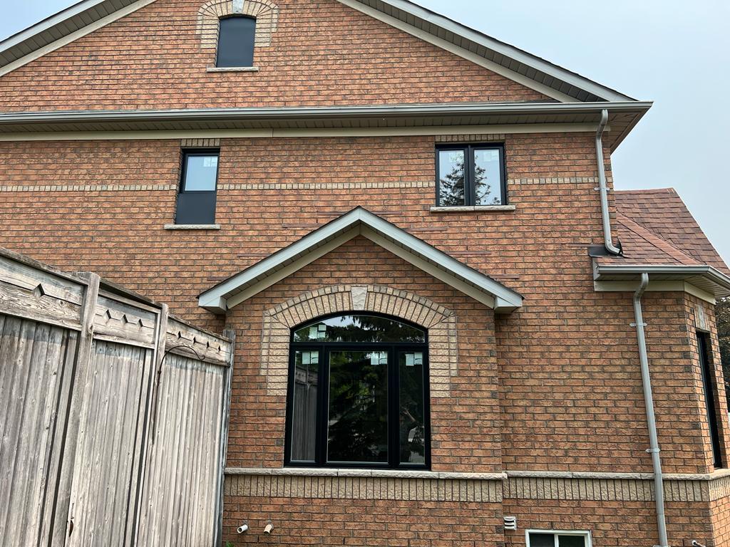 a brick house with variously designed windows